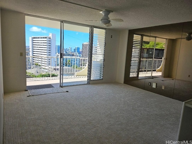 670 Prospect St Unit 606, Honolulu, HI 96813 - carpeted spare room with floor to ceiling windows, a ceiling fan, a view of skyline, and a textured ceiling