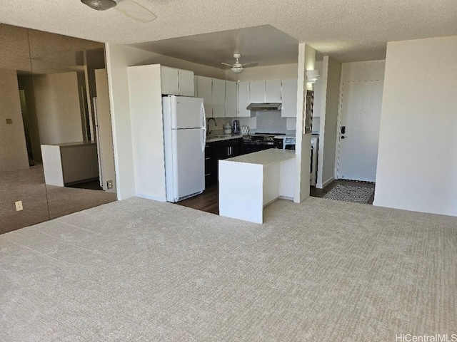 670 Prospect St Unit 606, Honolulu, HI 96813 - kitchen with freestanding refrigerator, ceiling fan, dark colored carpet, light countertops, and stainless steel range with electric cooktop