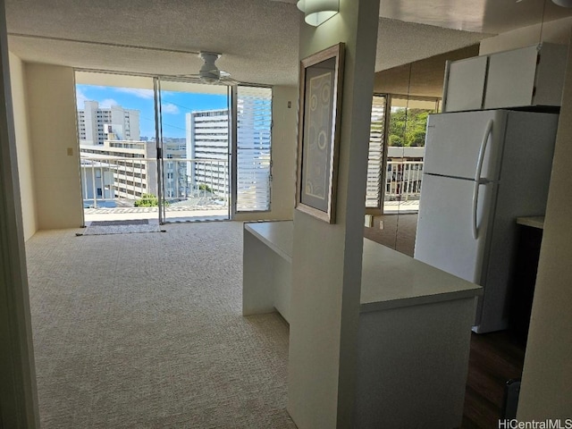 670 Prospect St Unit 606, Honolulu, HI 96813 - unfurnished dining area featuring expansive windows, a ceiling fan, a view of city, dark colored carpet, and a textured ceiling