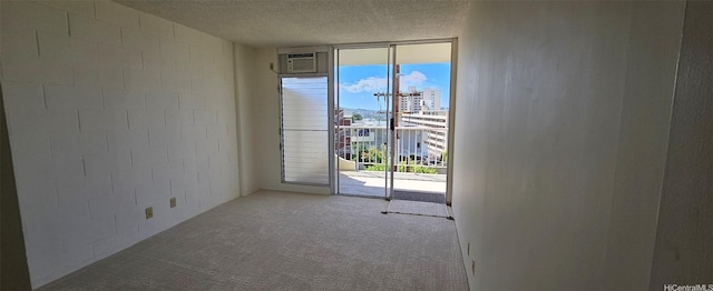 670 Prospect St Unit 606, Honolulu, HI 96813 - carpeted empty room featuring concrete block wall, a textured ceiling, a city view, and floor to ceiling windows