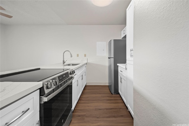 46-263 Kahuhipa St Unit B303, Kaneohe, HI 96744 - kitchen with appliances with stainless steel finishes, white cabinetry, dark wood-type flooring, a ceiling fan, and light stone counters