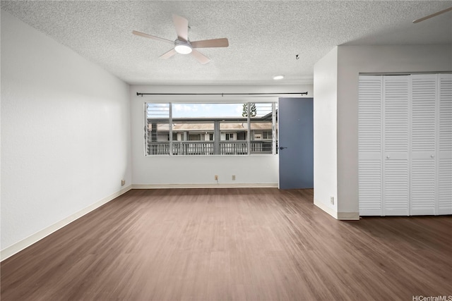 46-263 Kahuhipa St Unit B303, Kaneohe, HI 96744 - unfurnished living room with a ceiling fan, wood finished floors, and a textured ceiling