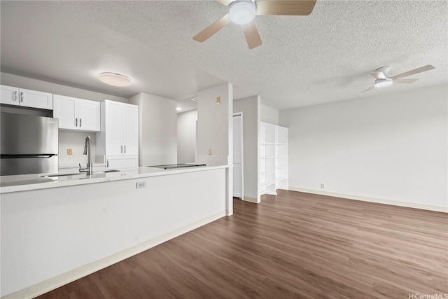 46-263 Kahuhipa St Unit B303, Kaneohe, HI 96744 - kitchen featuring freestanding refrigerator, a ceiling fan, wood finished floors, white cabinets, and a textured ceiling