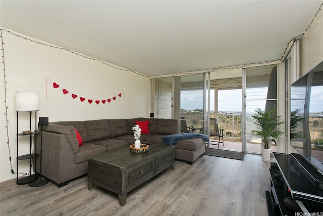98-719 Iho Pl Unit 5-703, Aiea, HI 96701 - living area with light wood finished floors and a wall of windows