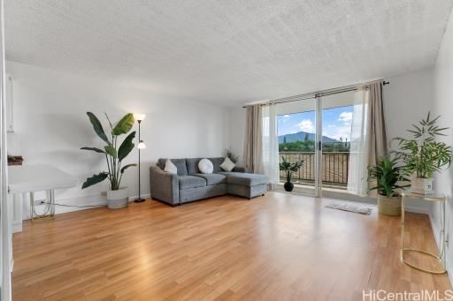 1830 Wilikina Dr Unit 602, Wahiawa, HI 96786 - living room with floor to ceiling windows, wood finished floors, and a textured ceiling