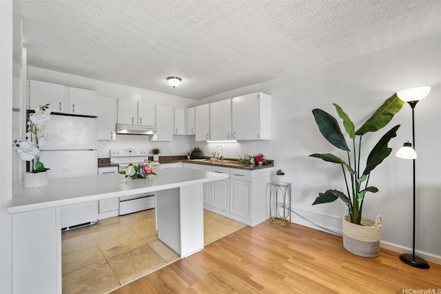 1830 Wilikina Dr Unit 602, Wahiawa, HI 96786 - kitchen with white appliances, under cabinet range hood, white cabinetry, a textured ceiling, and light tile patterned floors