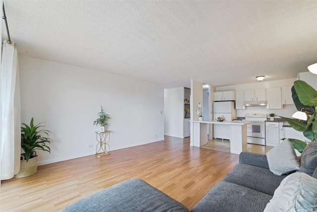 1830 Wilikina Dr Unit 602, Wahiawa, HI 96786 - living area featuring light wood-style floors and a textured ceiling