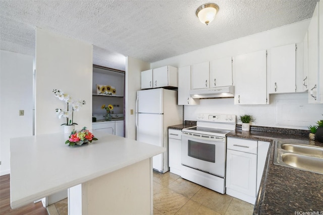 1830 Wilikina Dr Unit 602, Wahiawa, HI 96786 - kitchen with white appliances, under cabinet range hood, washer and clothes dryer, a textured ceiling, and white cabinets