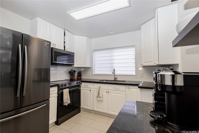 94-1010 Awalua St, Waipahu, HI 96797 - kitchen with freestanding refrigerator, black / electric stove, stainless steel microwave, and white cabinets