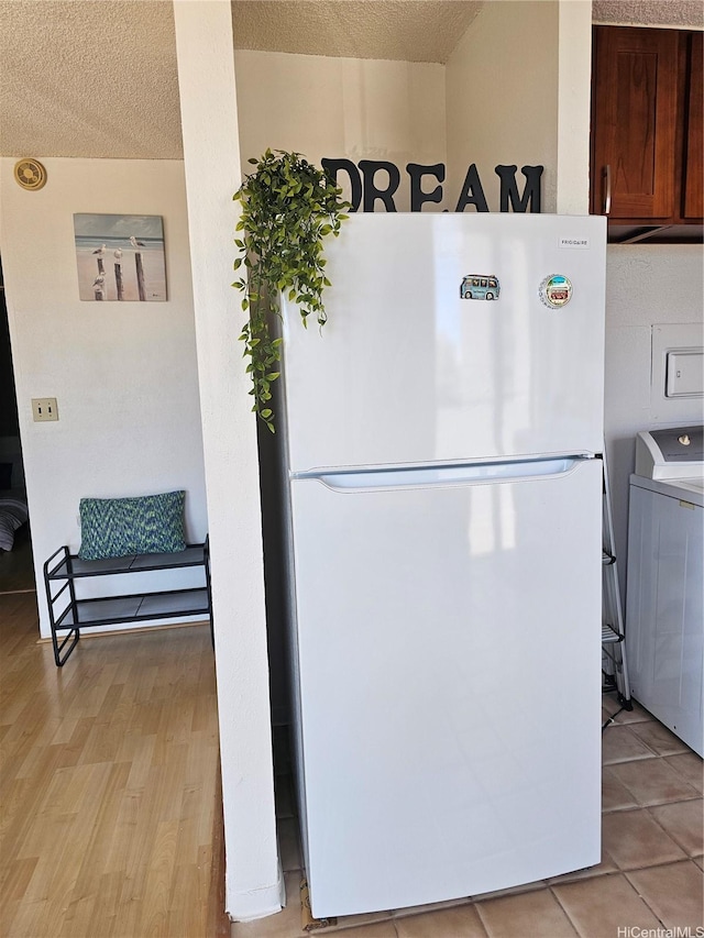 1702 Kewalo St Unit 204, Honolulu, HI 96822 - kitchen featuring freestanding refrigerator, washer / clothes dryer, a textured ceiling, and light wood-style floors