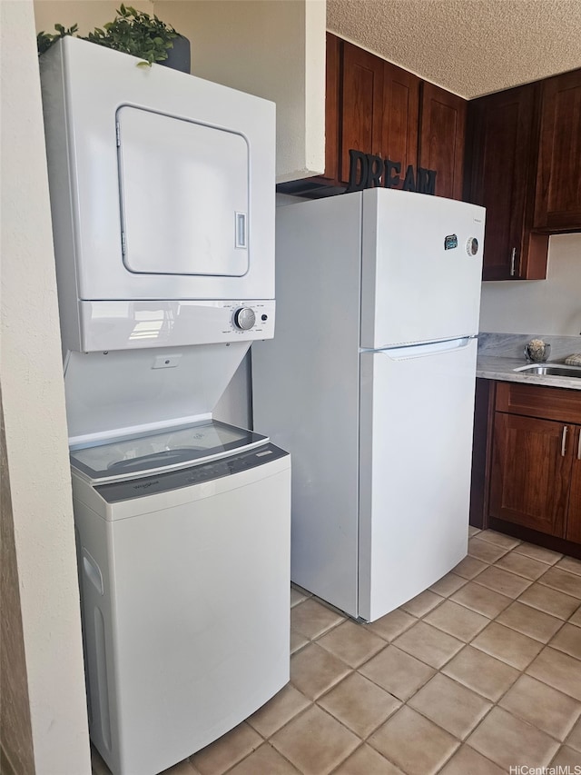 1702 Kewalo St Unit 204, Honolulu, HI 96822 - laundry room featuring stacked washer / dryer and light tile patterned flooring