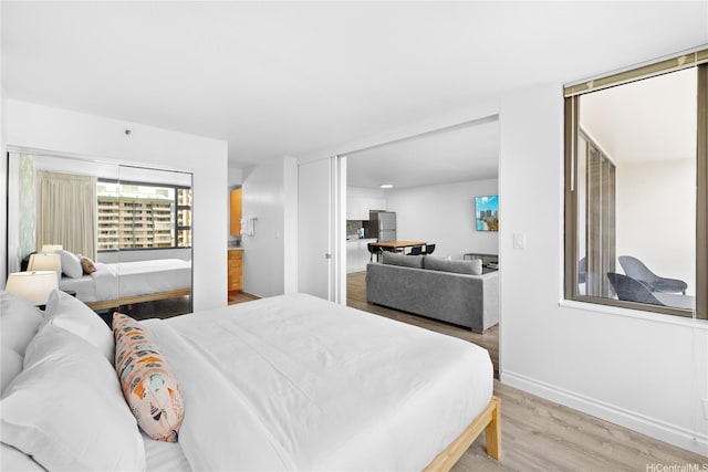 201 Oahu Ave Unit 1111, Honolulu, HI 96815 - bedroom with light wood-style floors and freestanding refrigerator