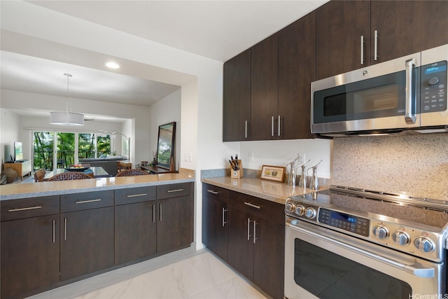 437 Kailua Rd Unit 6107, Kailua, HI 96734 - kitchen with stainless steel appliances, dark brown cabinetry, open floor plan, light stone countertops, and recessed lighting