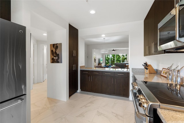 437 Kailua Rd Unit 6107, Kailua, HI 96734 - kitchen with stainless steel appliances, dark brown cabinets, light marble finish floors, recessed lighting, and light stone counters
