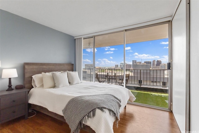 775 Kinalau Pl Unit 1806, Honolulu, HI 96813 - bedroom featuring access to exterior, wood finished floors, expansive windows, and a view of city