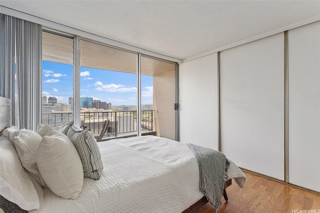 775 Kinalau Pl Unit 1806, Honolulu, HI 96813 - bedroom with access to exterior, wood finished floors, a city view, and a closet
