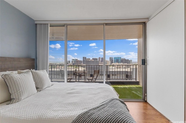 775 Kinalau Pl Unit 1806, Honolulu, HI 96813 - bedroom featuring expansive windows, access to outside, multiple windows, a view of skyline, and wood finished floors