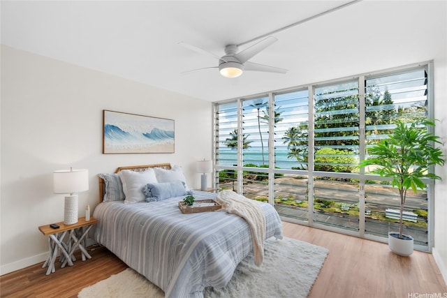 53-549 Kamehameha Hwy Unit 313, Hauula, HI 96717 - bedroom featuring wood finished floors, expansive windows, and a ceiling fan