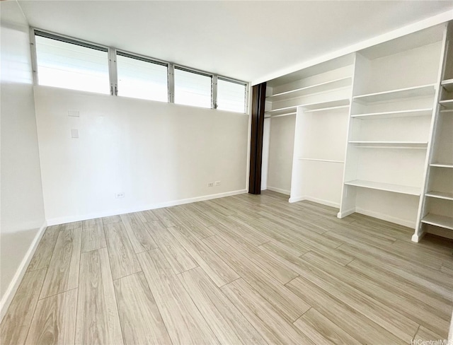 1556 Piikoi St Unit 506, Honolulu, HI 96822 - unfurnished bedroom featuring light wood-style flooring and a closet