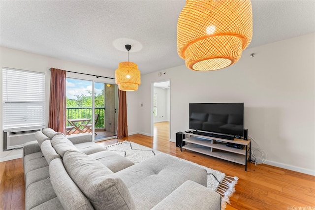 3075 Ala Poha Pl Unit 206, Honolulu, HI 96818 - living room featuring a textured ceiling and wood finished floors