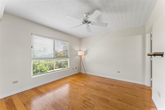 3075 Ala Poha Pl Unit 206, Honolulu, HI 96818 - unfurnished room featuring a textured ceiling, light wood-type flooring, and ceiling fan