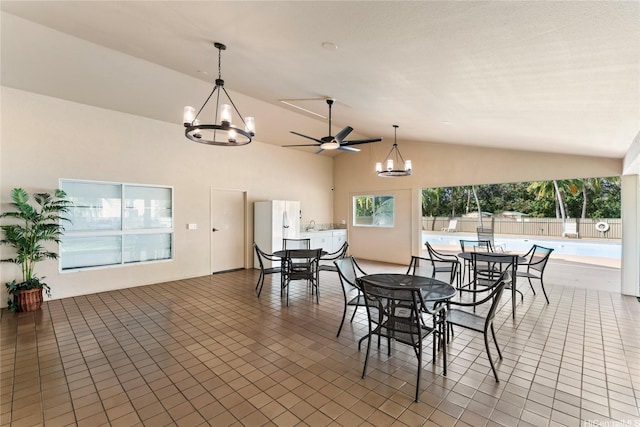 3075 Ala Poha Pl Unit 206, Honolulu, HI 96818 - dining area featuring a chandelier, vaulted ceiling, a ceiling fan, and tile patterned floors