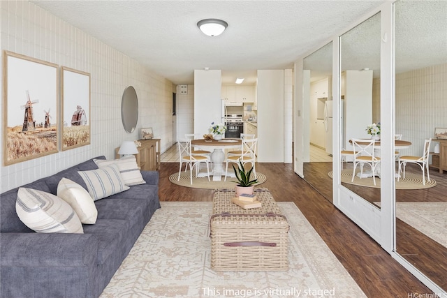 1605 Pensacola St Unit 104, Honolulu, HI 96822 - living room featuring wood finished floors and a textured ceiling
