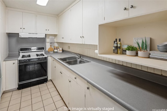 1605 Pensacola St Unit 104, Honolulu, HI 96822 - kitchen with gas range oven, under cabinet range hood, white cabinetry, and light tile patterned floors
