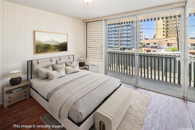 1605 Pensacola St Unit 104, Honolulu, HI 96822 - bedroom with access to exterior, tile walls, wood finished floors, and a wall mounted AC