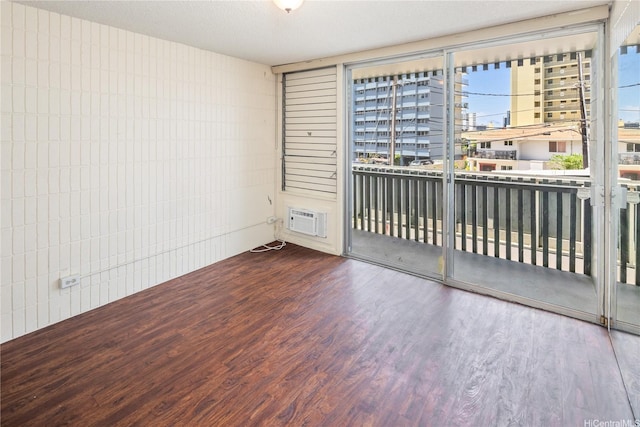 1605 Pensacola St Unit 104, Honolulu, HI 96822 - empty room with wood finished floors and an AC wall unit