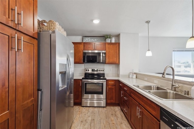 642 Kakala St Unit 1311, Kapolei, HI 96707 - kitchen with appliances with stainless steel finishes, light wood finished floors, light countertops, decorative light fixtures, and brown cabinetry
