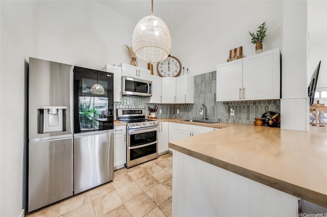91-1516 Keonekapu St, Ewa Beach, HI 96706 - kitchen with stainless steel appliances, a high ceiling, tasteful backsplash, white cabinetry, and light countertops