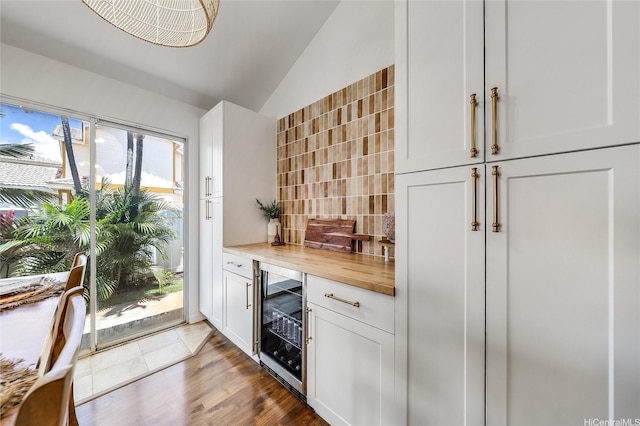 91-1516 Keonekapu St, Ewa Beach, HI 96706 - indoor dry bar featuring wine cooler, lofted ceiling, decorative backsplash, and wood finished floors