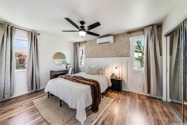 91-1516 Keonekapu St, Ewa Beach, HI 96706 - bedroom featuring a wall unit AC, a wainscoted wall, wood finished floors, and multiple windows