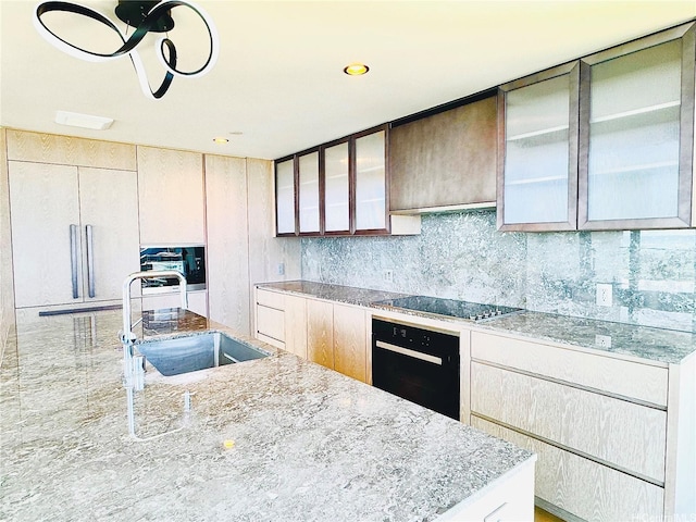 1000 Auahi St Unit 1600, Honolulu, HI 96814 - kitchen featuring oven, cooktop, light stone counters, glass insert cabinets, and backsplash
