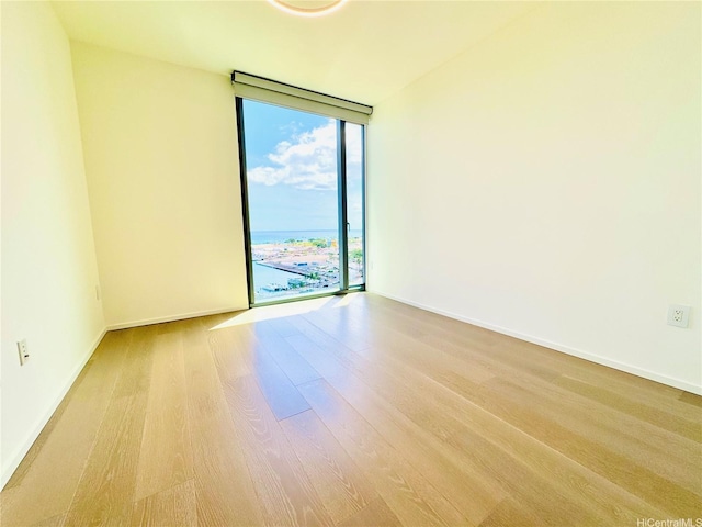 1000 Auahi St Unit 1600, Honolulu, HI 96814 - spare room featuring expansive windows and wood finished floors