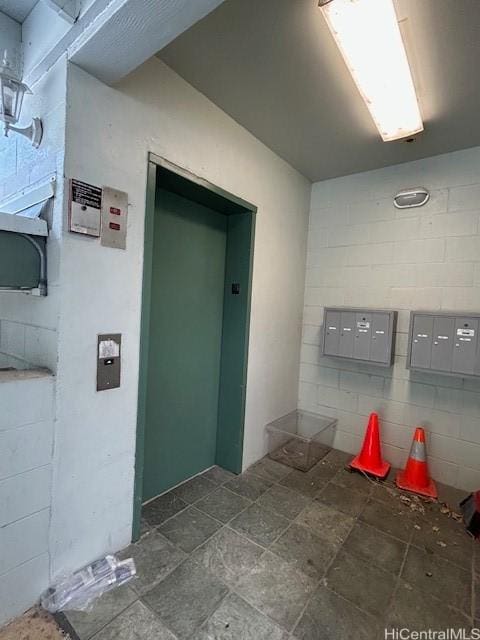 2556 Palolo Pl Unit 4B, Honolulu, HI 96816 - bathroom featuring mail area, elevator, and concrete block wall