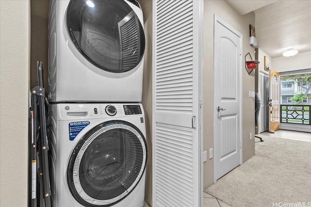 1180 Kakala St Unit 608, Kapolei, HI 96707 - laundry area featuring stacked washer and clothes dryer, carpet floors, and tile patterned floors