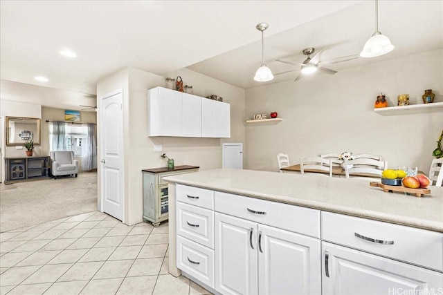 1180 Kakala St Unit 608, Kapolei, HI 96707 - kitchen with light colored carpet, a ceiling fan, white cabinets, decorative light fixtures, and light countertops