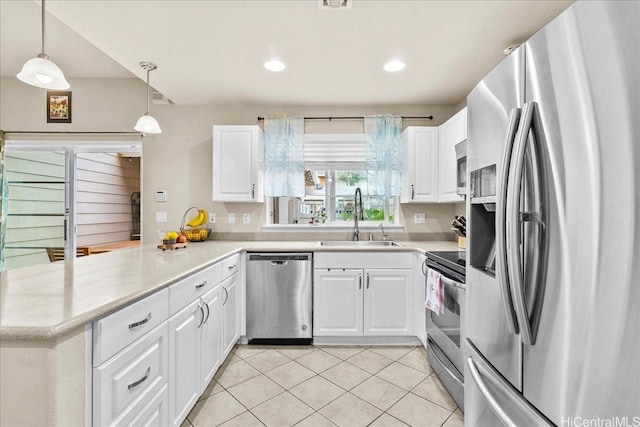 1180 Kakala St Unit 608, Kapolei, HI 96707 - kitchen with stainless steel appliances, a peninsula, light tile patterned floors, white cabinetry, and light countertops