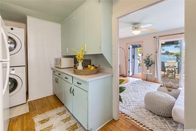 68-17 Laau Paina Pl, Waialua, HI 96791 - laundry area with stacked washer and clothes dryer, light wood-type flooring, and a ceiling fan