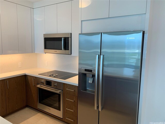 629 Keeaumoku St Unit 2310, Honolulu, HI 96814 - kitchen featuring stainless steel appliances, modern cabinets, white cabinets, and light countertops