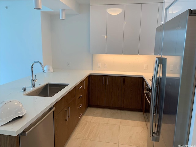 629 Keeaumoku St Unit 2310, Honolulu, HI 96814 - kitchen with freestanding refrigerator, dishwasher, modern cabinets, dark brown cabinetry, and white cabinetry