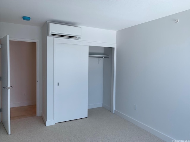 629 Keeaumoku St Unit 2310, Honolulu, HI 96814 - unfurnished bedroom featuring an AC wall unit, a closet, and light carpet