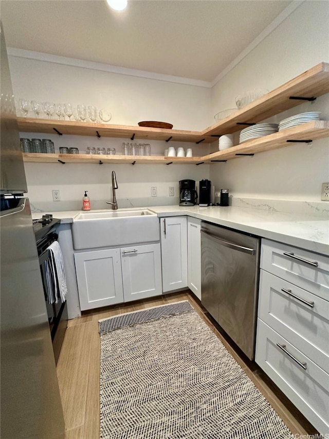 57-68 Eleku Kuilima Pl Unit 657, Kahuku, HI 96731 - kitchen featuring stainless steel dishwasher, open shelves, crown molding, freestanding refrigerator, and light countertops