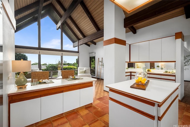 46-478 Haiku Plantations Dr, Kaneohe, HI 96744 - kitchen featuring high vaulted ceiling, light countertops, white cabinetry, a peninsula, and open floor plan