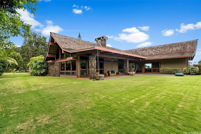 46-478 Haiku Plantations Dr, Kaneohe, HI 96744 - back of house featuring a lawn, board and batten siding, stone siding, and a patio area