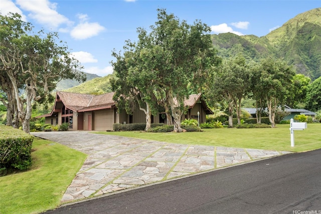 46-478 Haiku Plantations Dr, Kaneohe, HI 96744 - view of front of property featuring a garage, a mountain view, driveway, and a front yard