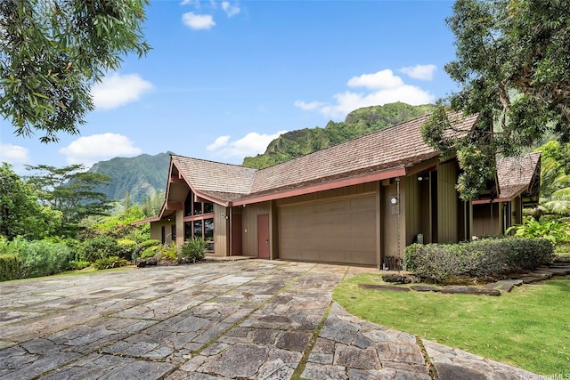 46-478 Haiku Plantations Dr, Kaneohe, HI 96744 - view of front of house featuring an attached garage, a mountain view, and driveway