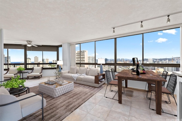 2499 Kapiolani Blvd Unit 2708, Honolulu, HI 96826 - living room featuring a view of skyline, ceiling fan, and light tile patterned flooring